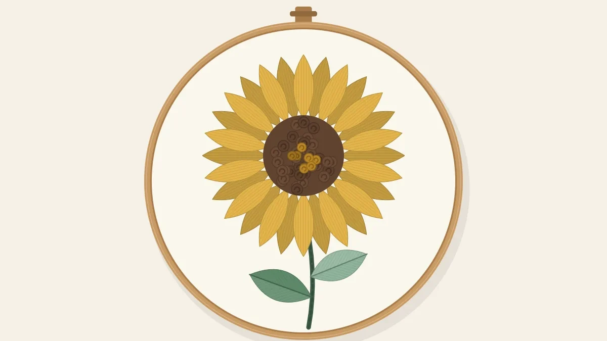 One large embroidered sunflower with golden petals and a dark brown knotted center, on a green stem in a wooden hoop