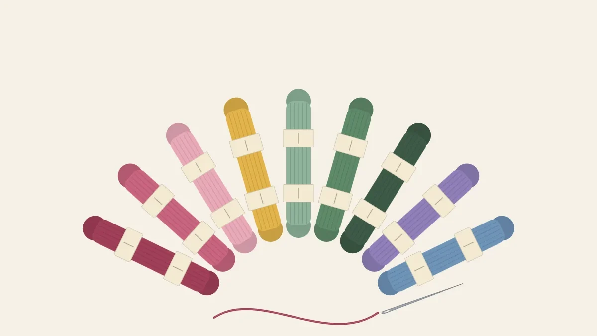 A fan of floss skeins in botanical colors with a threaded needle in front