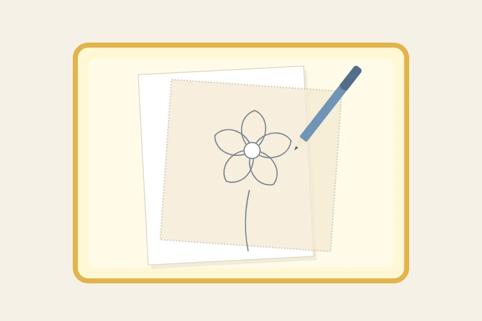 A glowing light box with a paper pattern on it, fabric laid on top and a pen tracing the outline of a flower
